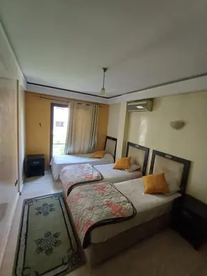 a bedroom with two beds and a window at Résidence les amis 2 chambres appartement familial in Marrakech