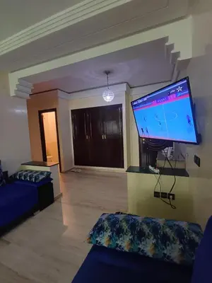 a living room with a large flat screen tv at Résidence les amis 2 chambres appartement familial in Marrakech