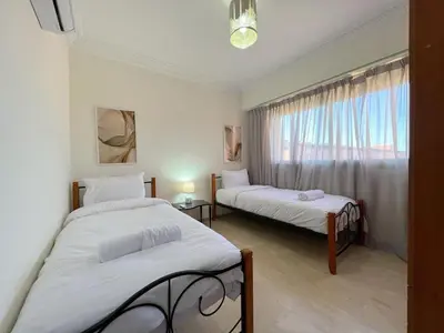 two beds in a room with a window at Stylish Stay downtown in Marrakech