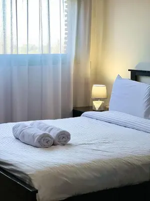 two towels on a bed in a bedroom with a window at Stylish Stay downtown in Marrakech