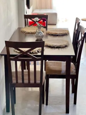 a dining room table with two chairs and a table with a table at Stylish Stay downtown in Marrakech
