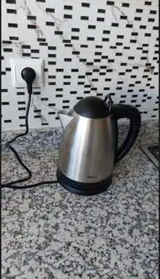 a tea kettle sitting on a counter next to an outlet at Kech Amal Apartment in Marrakech