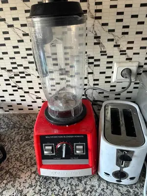 a red and white blender sitting next to a toaster at Kech Amal Apartment in Marrakech