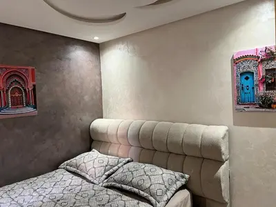 a bedroom with a bed and a couch at Marrakech Luxe & confort Appartement in Marrakech