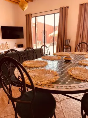 a dining room with a table and chairs at Dar Tal, Marrakech in Douar Oulad Ali