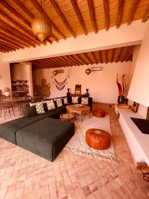a living room with a couch and a table at Dar Tal, Marrakech in Douar Oulad Ali