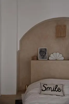 a bedroom with a large headboard and a white bed at Riad Nūr in Marrakech