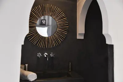 a bathroom with a sink and a mirror at Riad Nūr in Marrakech