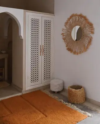 a room with a white cabinet and a mirror at Riad Nūr in Marrakech