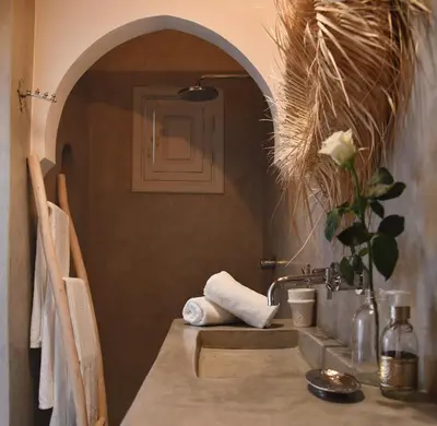 a table with a sink in a room at Riad Nūr in Marrakech