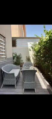 two wicker chairs and a table on a patio at Appartement calme chez Nawal in Marrakech