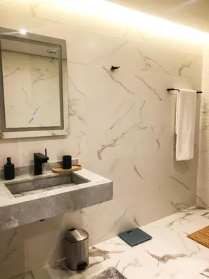 a bathroom with a sink and a mirror at Modern 2BR, Pool Access, Fast Wi-Fi in Marrakech