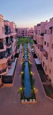 an aerial view of a courtyard with a pool between buildings at Modern 2BR, Pool Access, Fast Wi-Fi in Marrakech