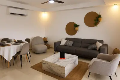 a living room with a couch and a table at Noria Golf - séjour chic et zen à Marrakech in Marrakech