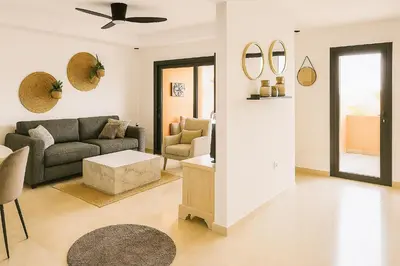 a living room with a couch and a table at Noria Golf - séjour chic et zen à Marrakech in Marrakech