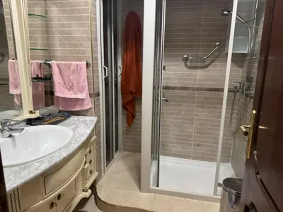 a bathroom with a sink and a shower at Al acadimya in Marrakech