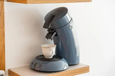 a blue coffee maker sitting on a shelf at Warm Nest 5 Central And Peaceful in Marrakech