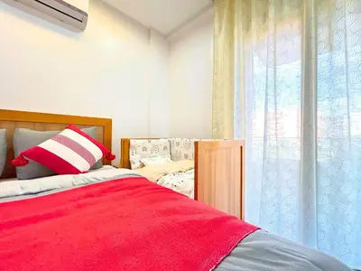 a bedroom with a red bed and a window at Warm Nest 5 Central And Peaceful in Marrakech