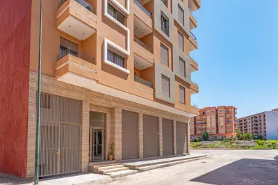 a tall brick building with a gate in front of it at Warm Nest 5 Central And Peaceful in Marrakech