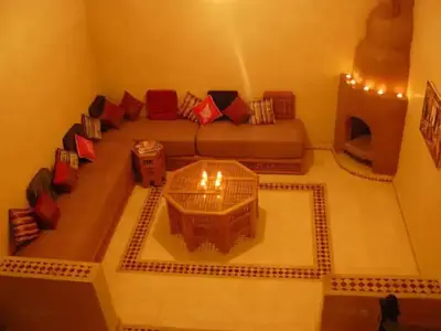 a living room with a couch and a bird cage at Riad Marrakech - Piscine -Wifi- résidence qarya essyahia in Marrakech