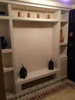 a shelf in a bathroom with some vases on it at Riad Marrakech - Piscine -Wifi- résidence qarya essyahia in Marrakech