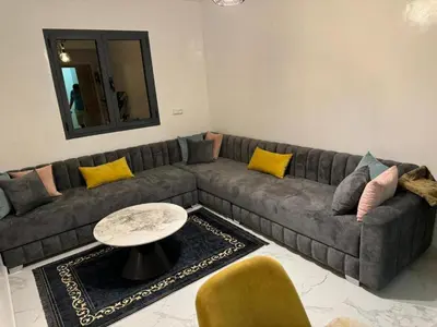 a living room with a couch and a table at Marrakech Riad in Marrakech