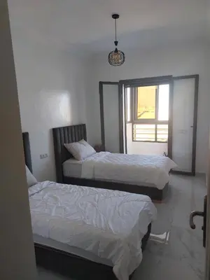 a bedroom with two beds and a window at Marrakech Riad in Marrakech