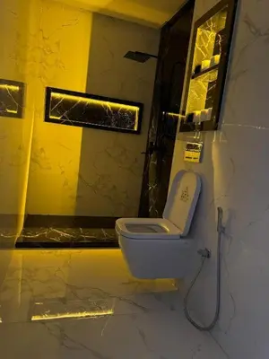 a bathroom with a white toilet in a yellow room at Marrakech Riad in Marrakech