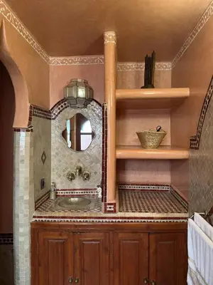 a bathroom with a sink and a mirror at Riad El Wiam in Marrakech