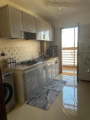 a kitchen with white cabinets and a stove top oven at Jasmine house in Marrakech in Marrakech