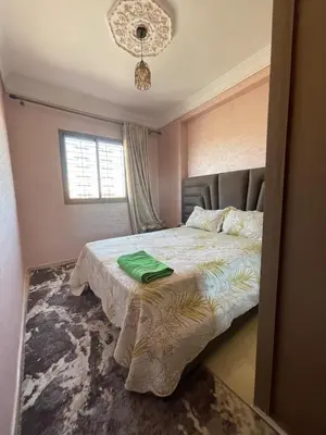 a bedroom with a bed with a green towel on it at Jasmine house in Marrakech in Marrakech
