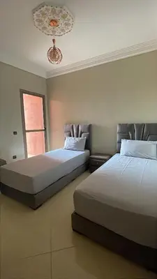 two beds sitting next to each other in a bedroom at Jasmine house in Marrakech in Marrakech