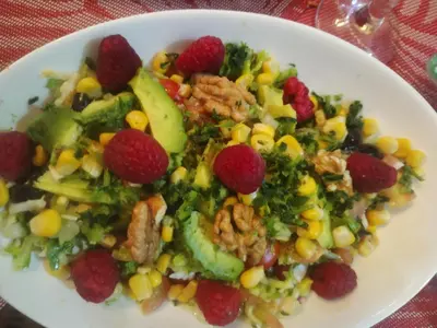 a white plate with a salad with corn and berries at dar sarsar airport 2 in Marrakech