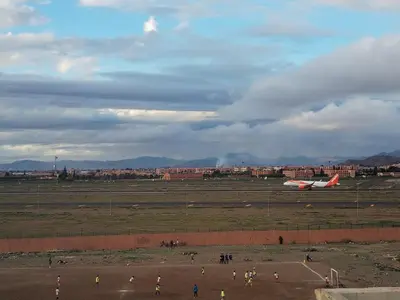 a group of people standing in a field near an airplane at dar sarsar airport 2 in Marrakech