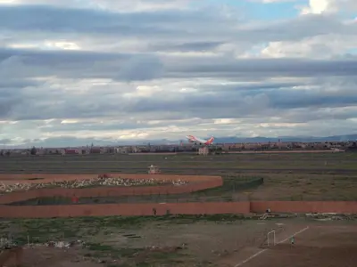 a large field with an airplane in the distance at dar sarsar airport 2 in Marrakech