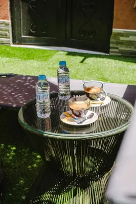 two water bottles and two cups on a glass table at Villa 4 bedrooms with private pool in Marrakech in Marrakech