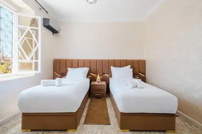 two twin beds in a room with a window at Villa 4 bedrooms with private pool in Marrakech in Marrakech