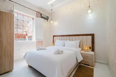 a bedroom with a large white bed and a window at Villa 4 bedrooms with private pool in Marrakech in Marrakech