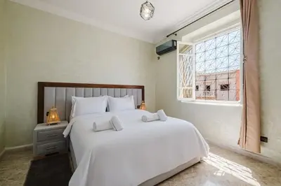 a bedroom with a large white bed and a window at Villa 4 bedrooms with private pool in Marrakech in Marrakech