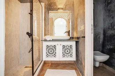 a bathroom with a sink and a mirror at Riad Dar Rafaël in Marrakech