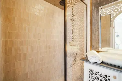 a bathroom with a sink and a shower at Riad Dar Rafaël in Marrakech
