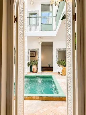 a pool in the middle of a house at Riad Dar Rafaël in Marrakech