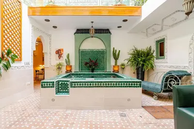 a room with a pool in the middle of a building at Riad Dar Nana in Marrakech