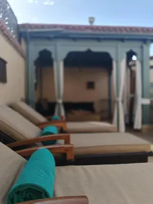 a close up of a couch with green towels on it at Riad Dar Nana in Marrakech