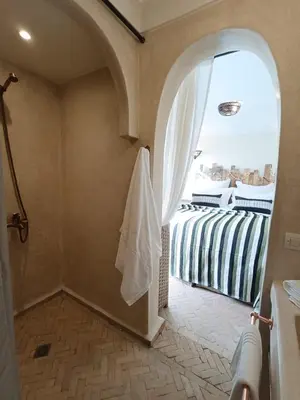 a bathroom with a shower and a window at Riad Dar Nana in Marrakech