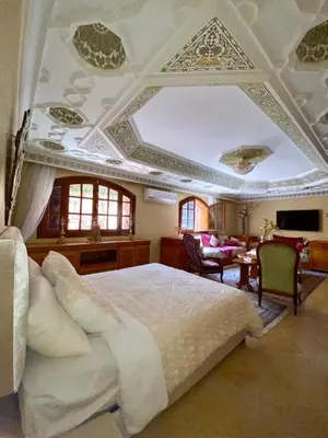a bedroom with a large bed and a living room at Villa floor Espace ouvert in Marrakech