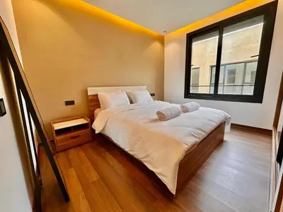 a bedroom with a large bed and a window at Quiet & Cosy Apartment in Central Gueliz in Marrakech