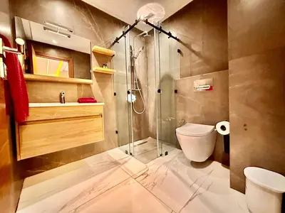 a bathroom with a glass shower and a toilet at Quiet & Cosy Apartment in Central Gueliz in Marrakech