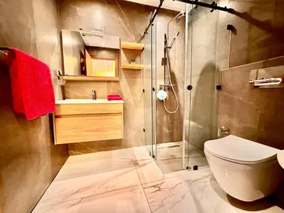 a bathroom with a shower and a toilet and a sink at Quiet & Cosy Apartment in Central Gueliz in Marrakech
