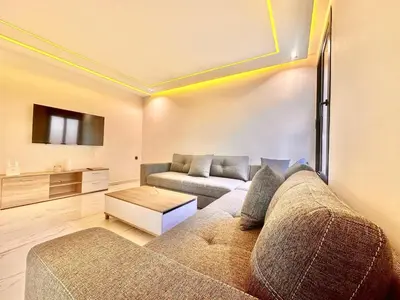 a living room with a couch and a tv at Quiet & Cosy Apartment in Central Gueliz in Marrakech